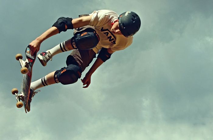 A skateboarder doing a trick in the air