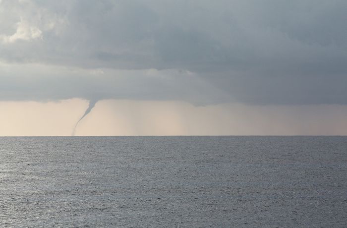 A waterspout hovering over the ocean