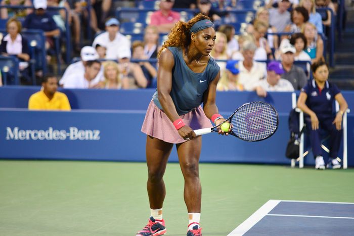 Serena Williams serving during a tennis match