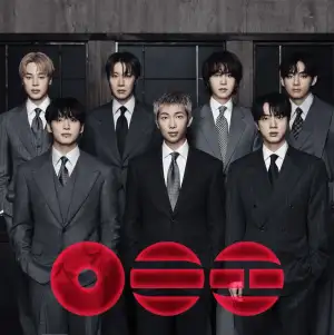 Album cover for the Arirang by BTS. Mostly white with 3 red circular images at the bottom.