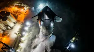 A rocket with steam gathering around its base as it gets ready to launch.